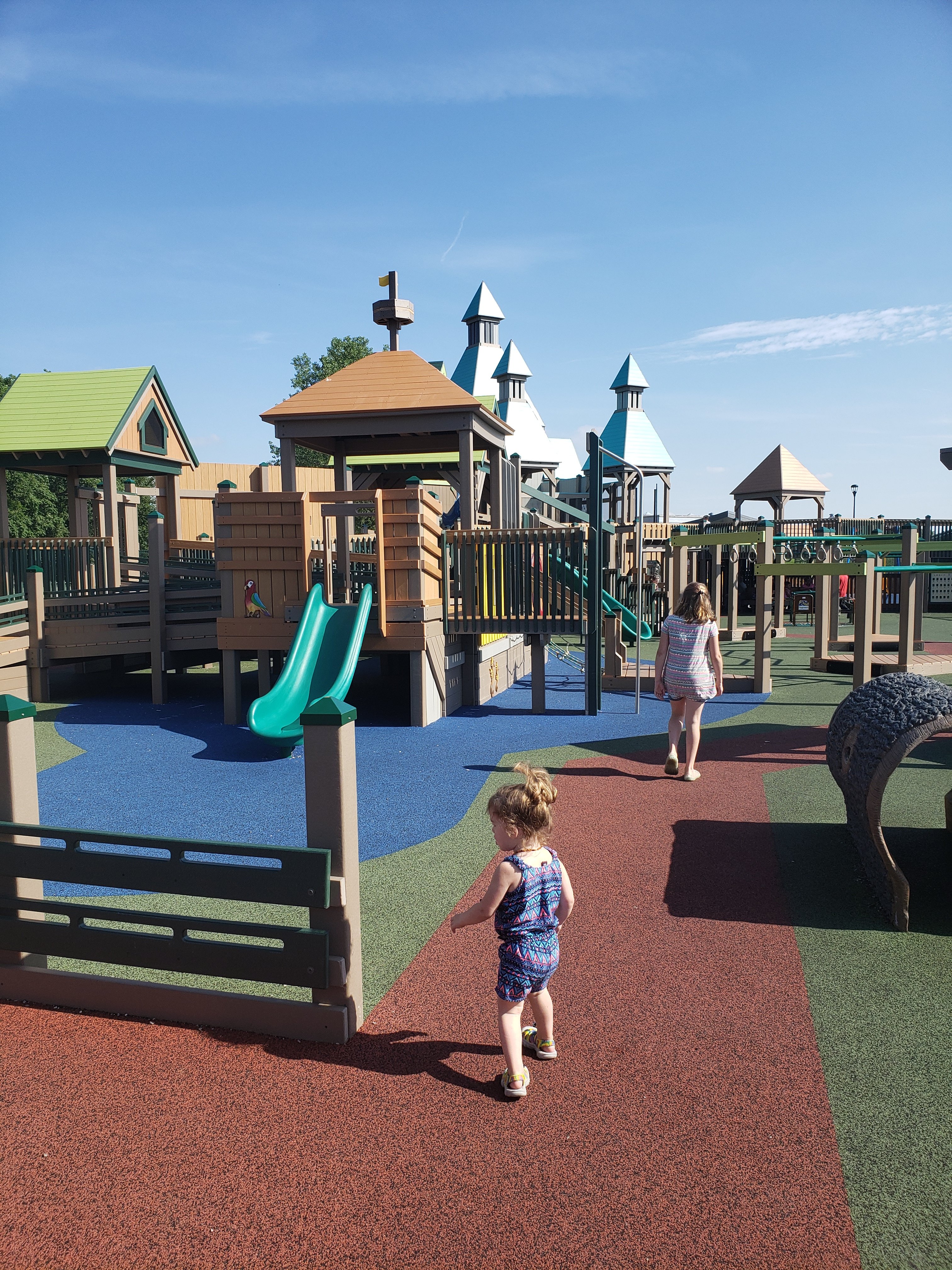 An older female child and a toddler girl exploring the park at Mickey's Kingdom Park for kids in Evansville, Indiana  Things to do with kids in Evansville Indiana. Kids activities in Evansville 