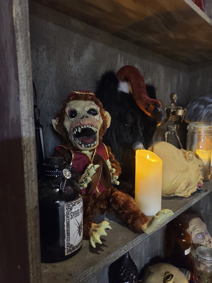 Night of the Living Fed scary monkey and vulture display with candles and other Halloween decor