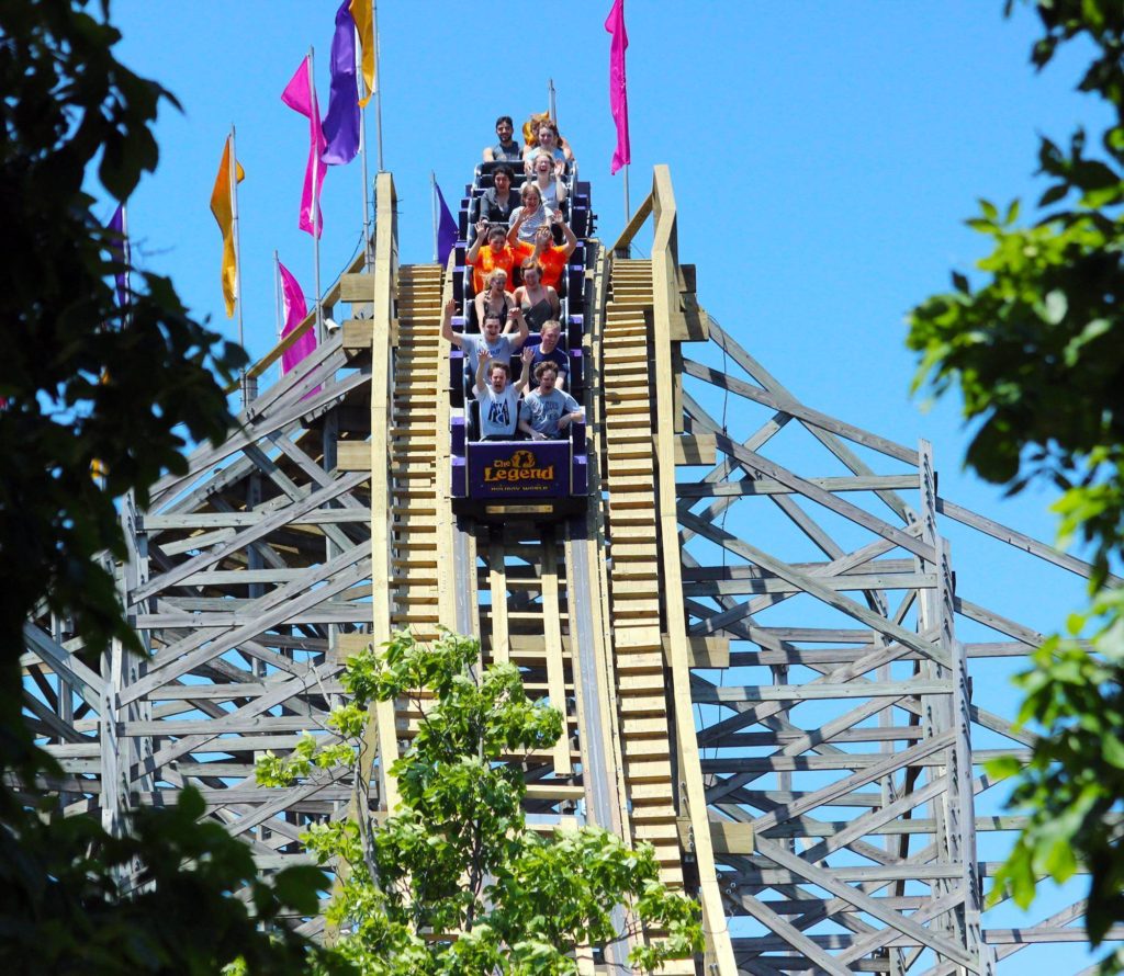 roller coaster car full of people going down a roller coaster