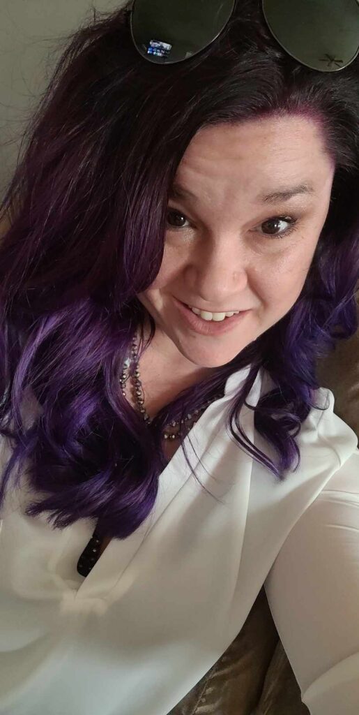 Woman with violet purple hair wearing a white shirt embrace your true self and embrace being too much 