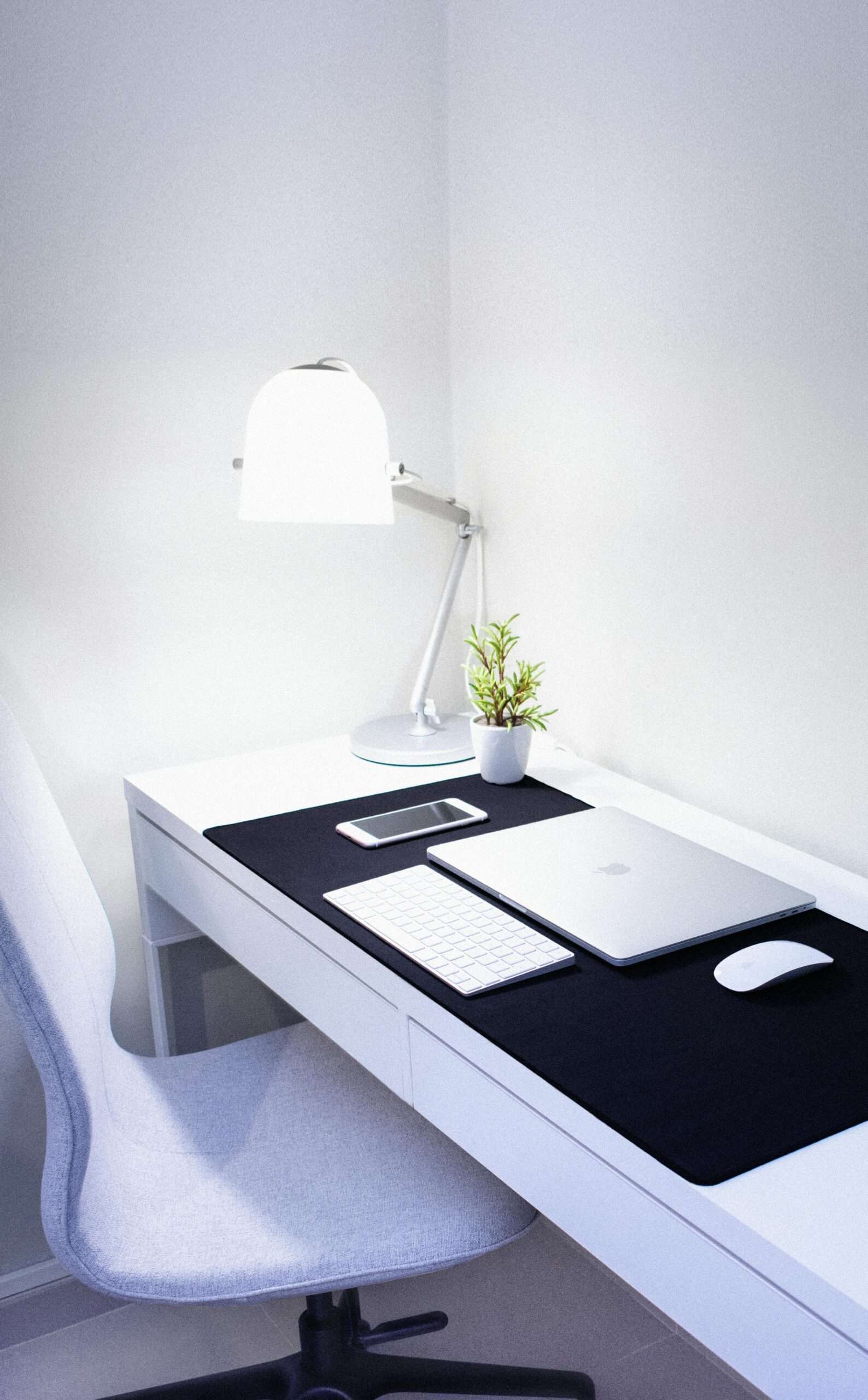 Clean white desk with good desk lamp as work from home gifts for remote workers